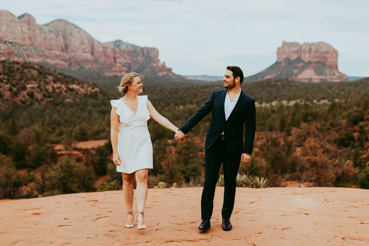 couple walks towards the camera for engagement photos