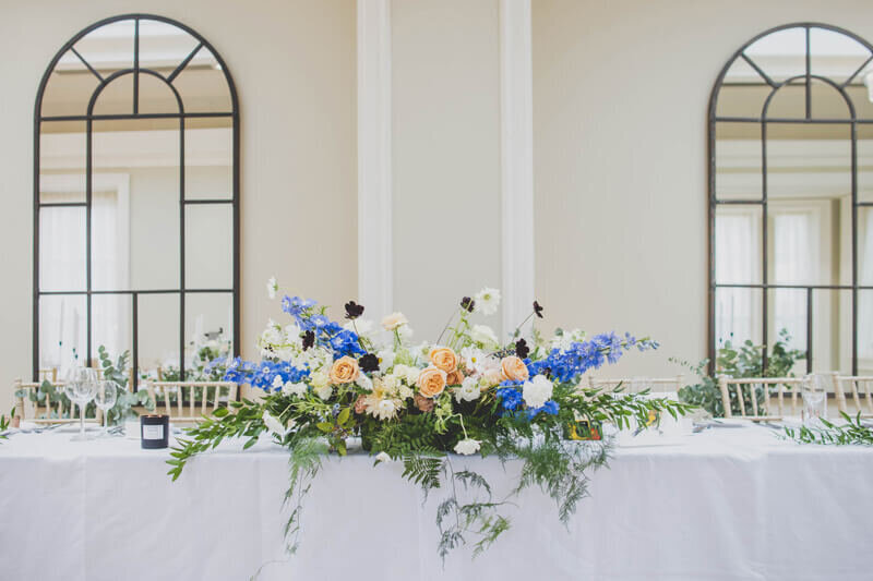 Stunning top table wedding flowers by the little flower hut