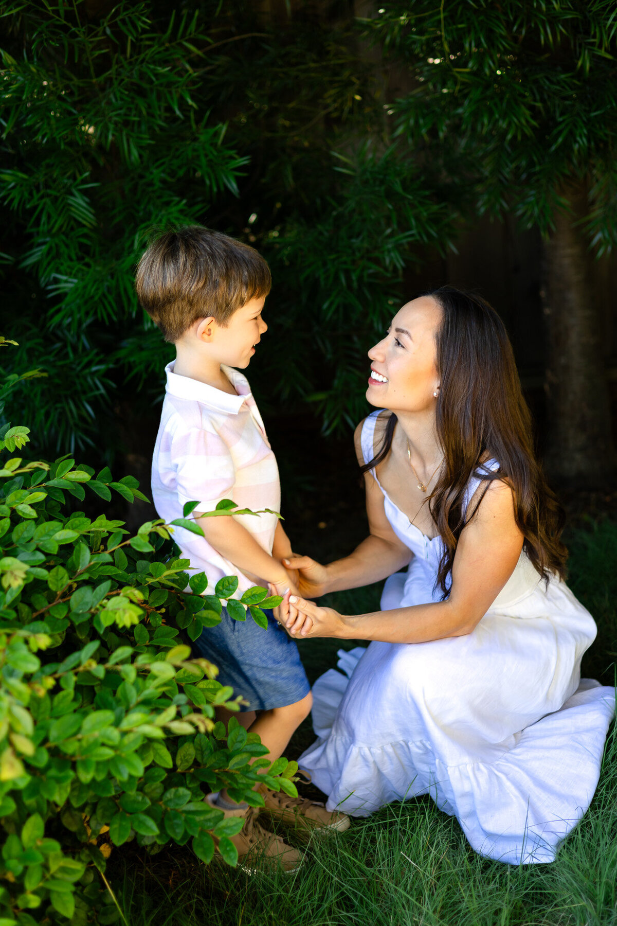 Mother kneeling to talk and smile with son in garden, Bay Area Family Portfolio – Ellobelle Photography