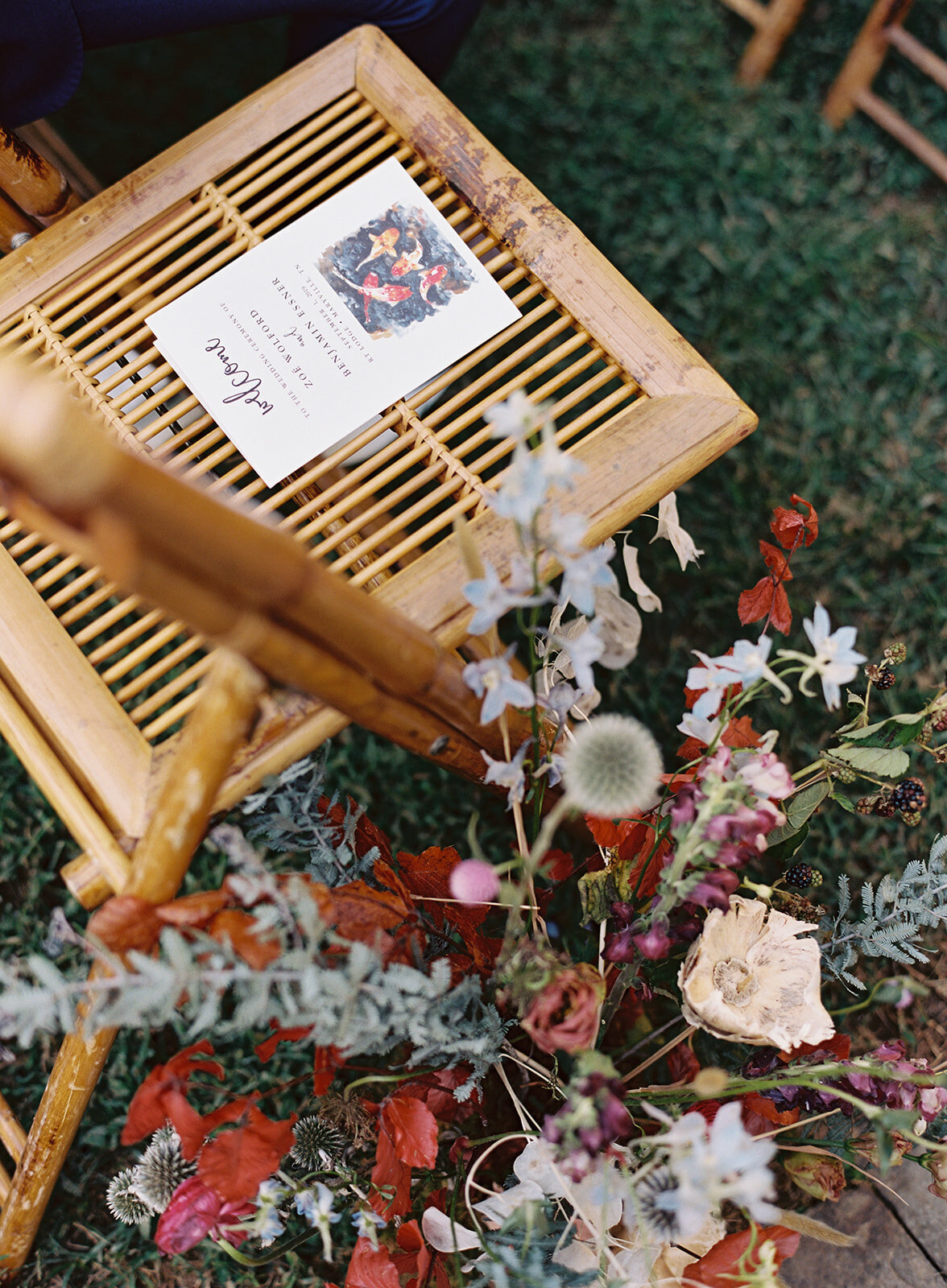 Aisle lined with wildflowers in bright, early fall color palette. RT Lodge wedding flowers. Designed by Rosemary and Finch in Nashville, TN.