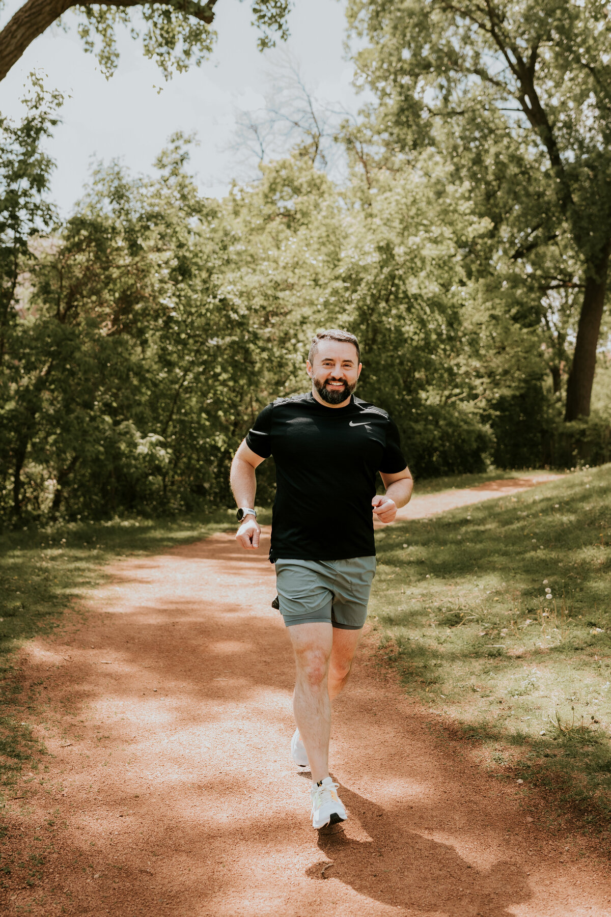 Natural light dating profile photo of a runner in motion on a scenic Minneapolis trail, styled for an active and adventurous dating profile.