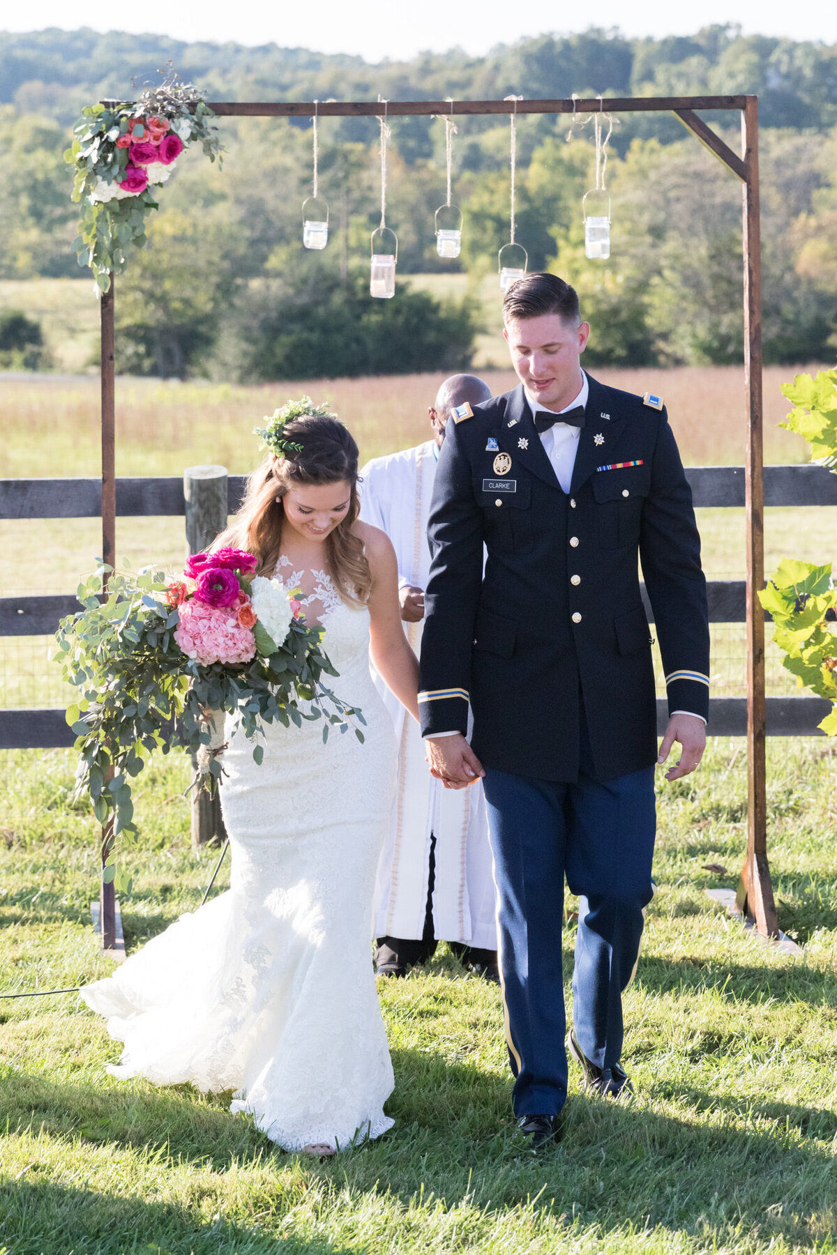 Bride and groom holding hands walking after being married