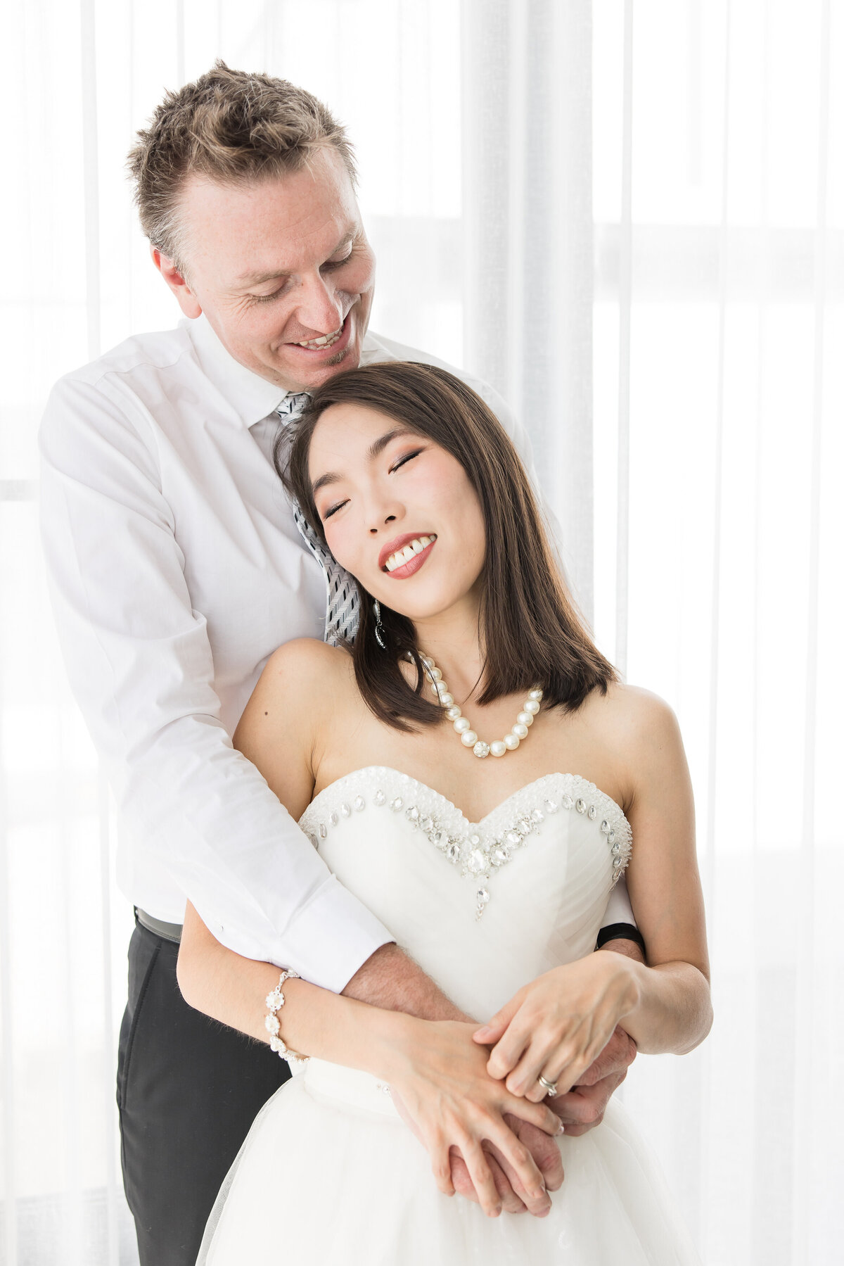 bride embraced by groom