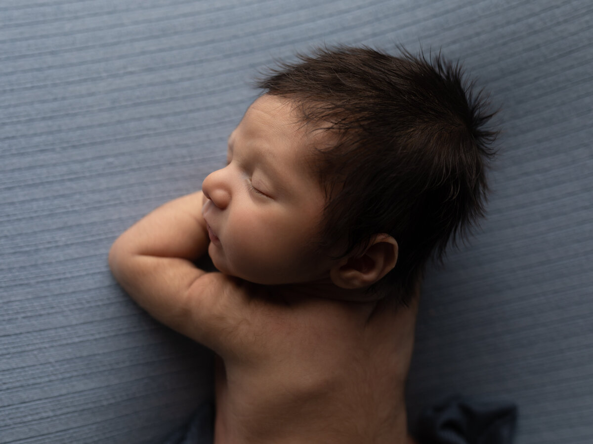 photo of newborn baby boy in blue for studio portraits