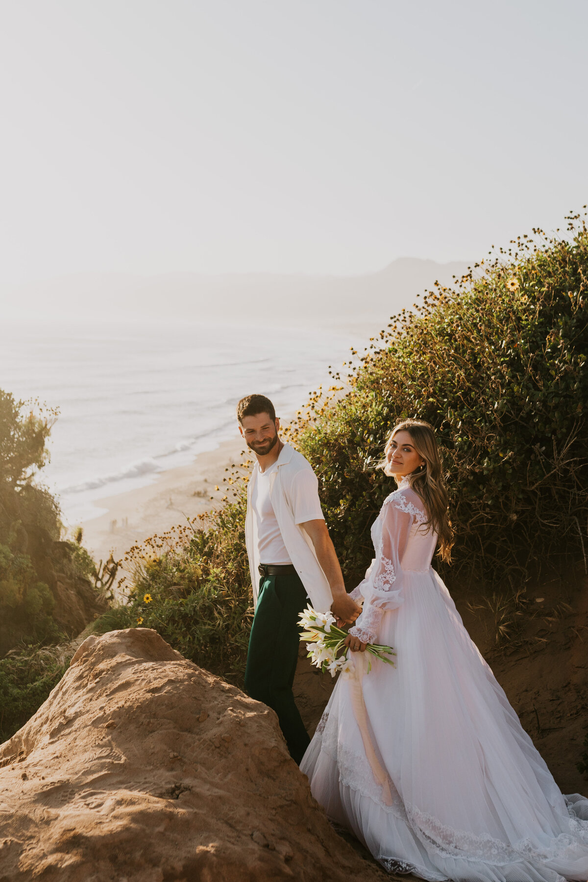 Bride and groom hand-in-hand in nature, authentic Indiana wedding portrait.