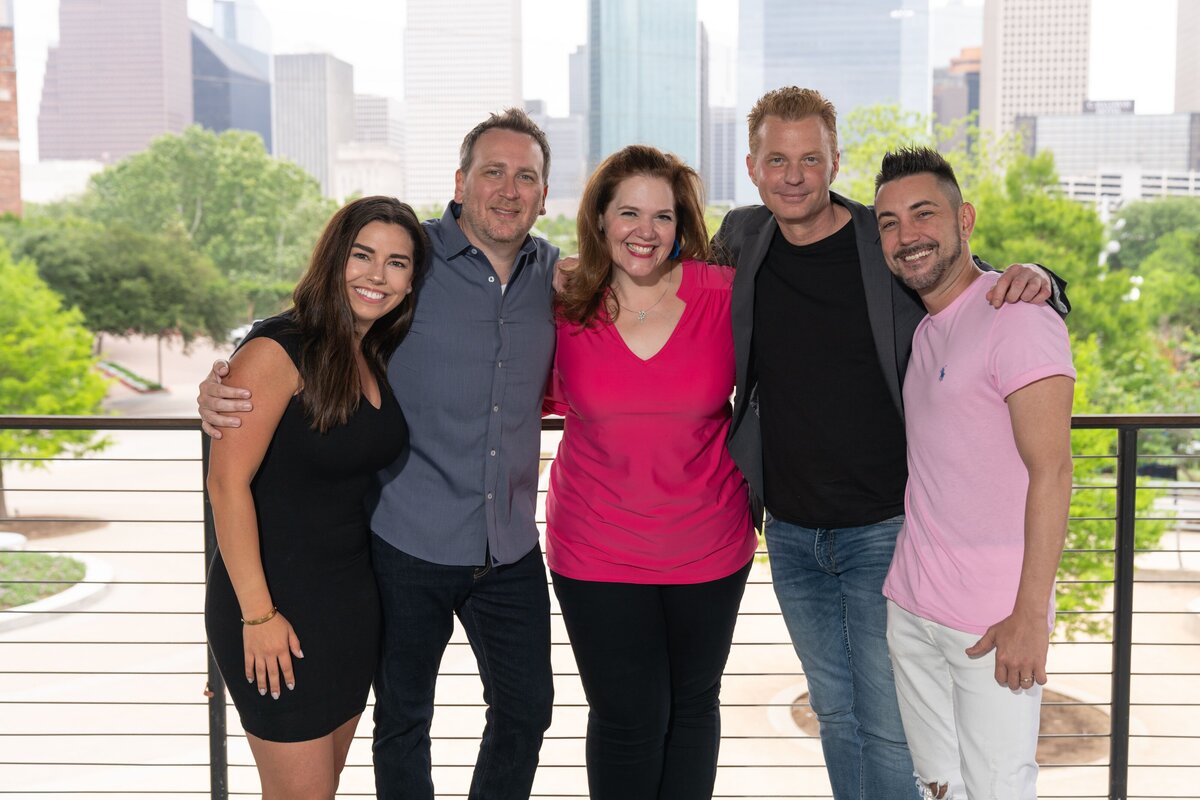 The Roula and Ryan Show posing in front of Downtown Houston for Houston freelance photographer