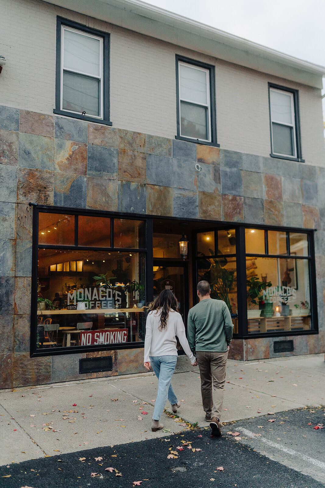 Couple walking towards a coffee shop at Finger Lakes engagement session