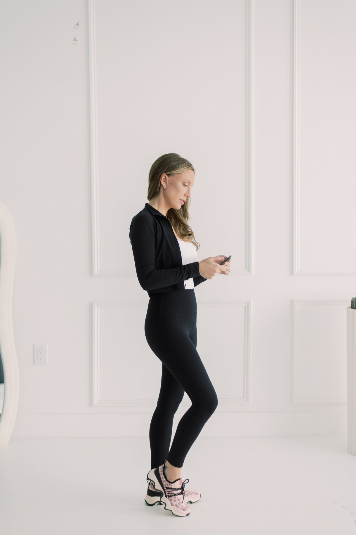 Candid moment of entrepreneur smiling while reviewing content on mobile phone
