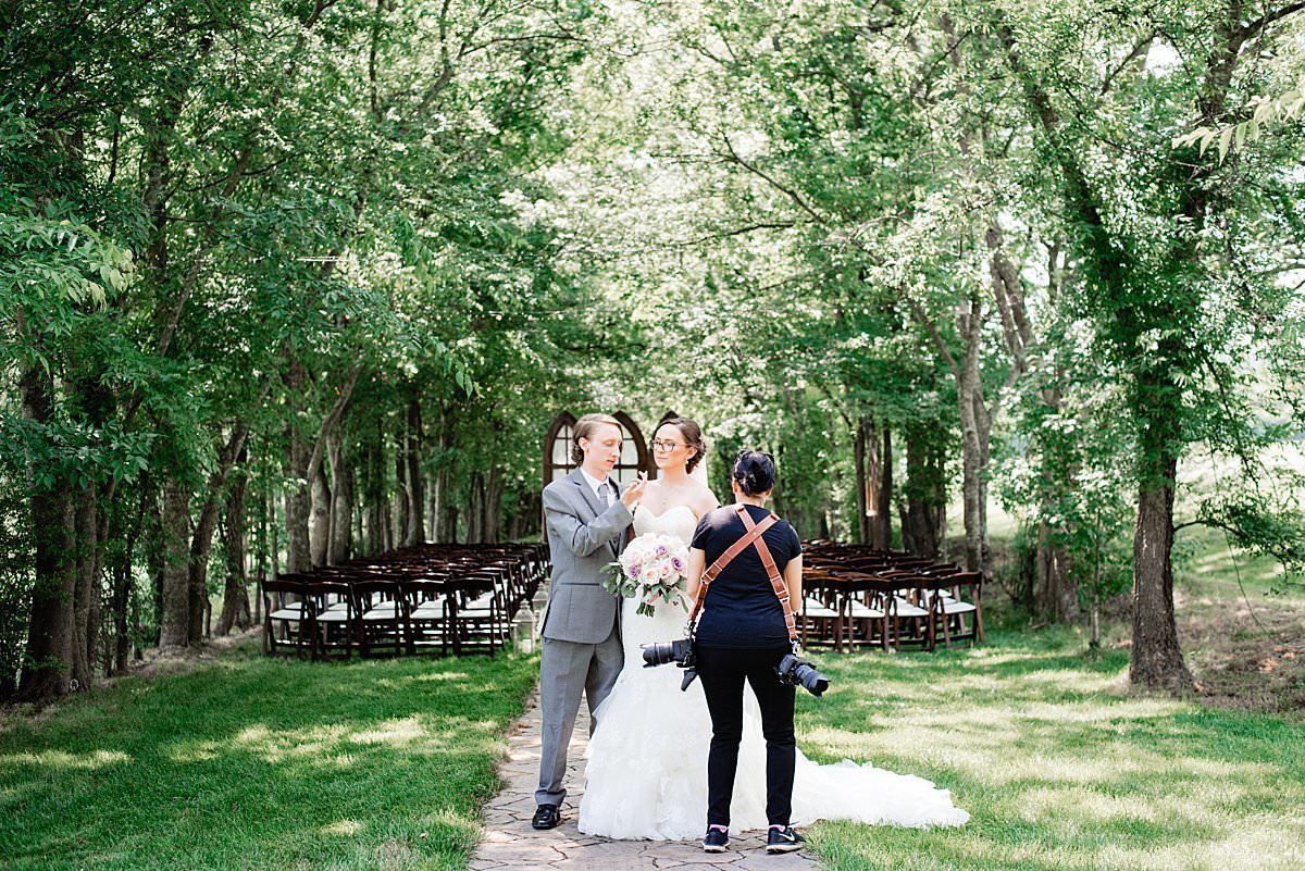 Photographer helping bride and groom  during their photos at Grace Valley Farm