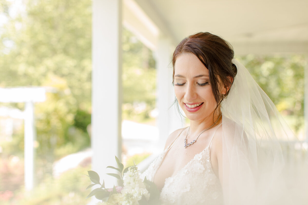 romantic bride looking at bouquet