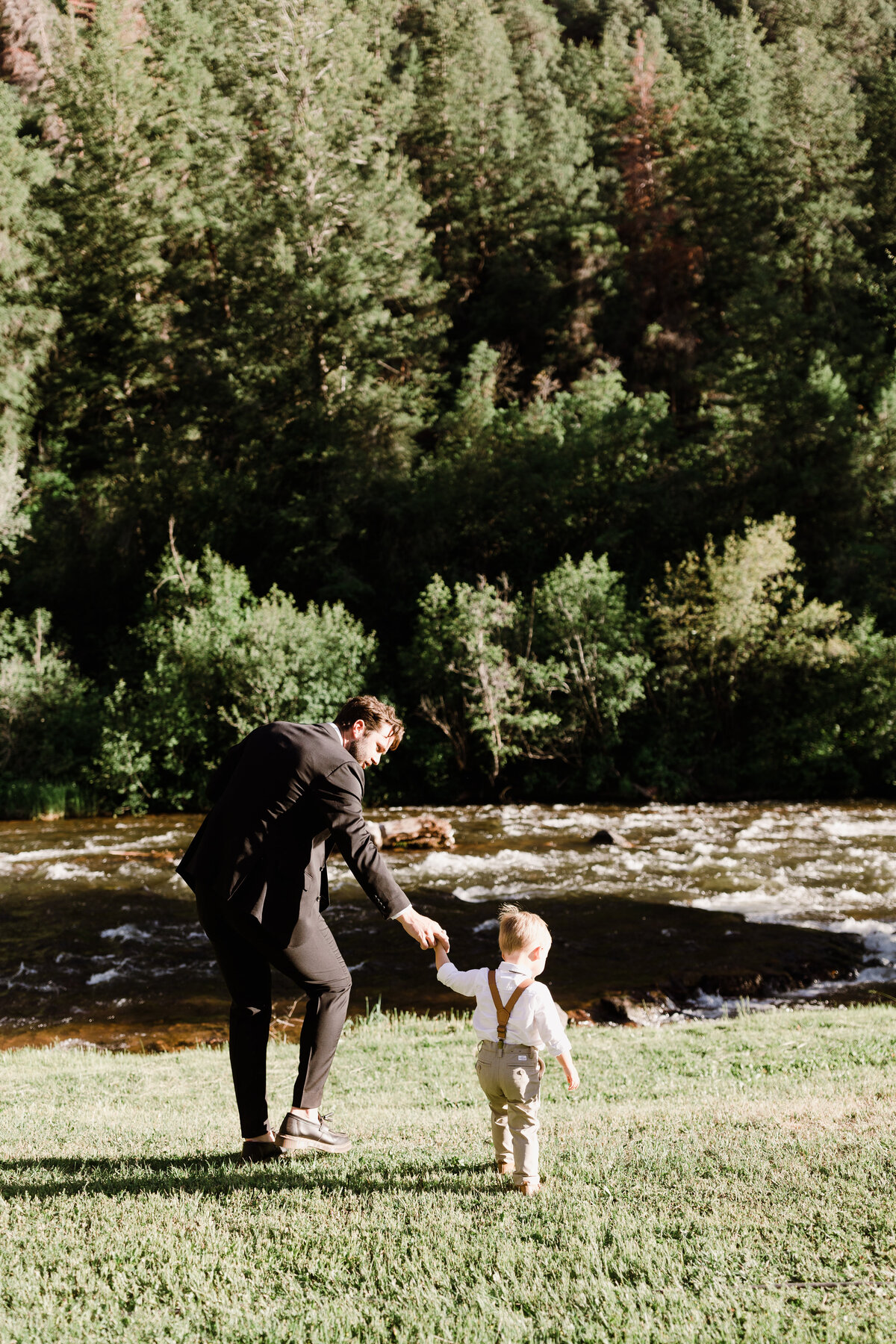 Young boy holding hands with dad at Dallenbach Ranch Colorado