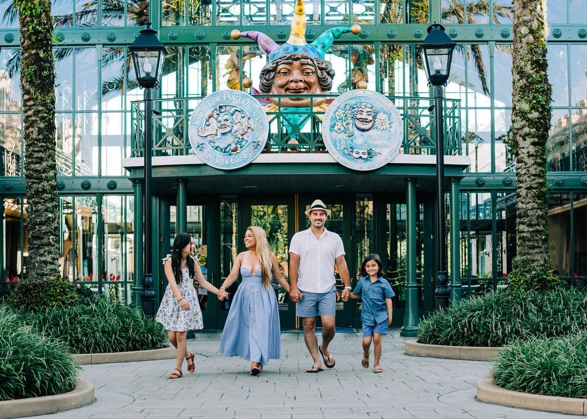 Family photo walking and holding hands at Disney's French Quarter Resort