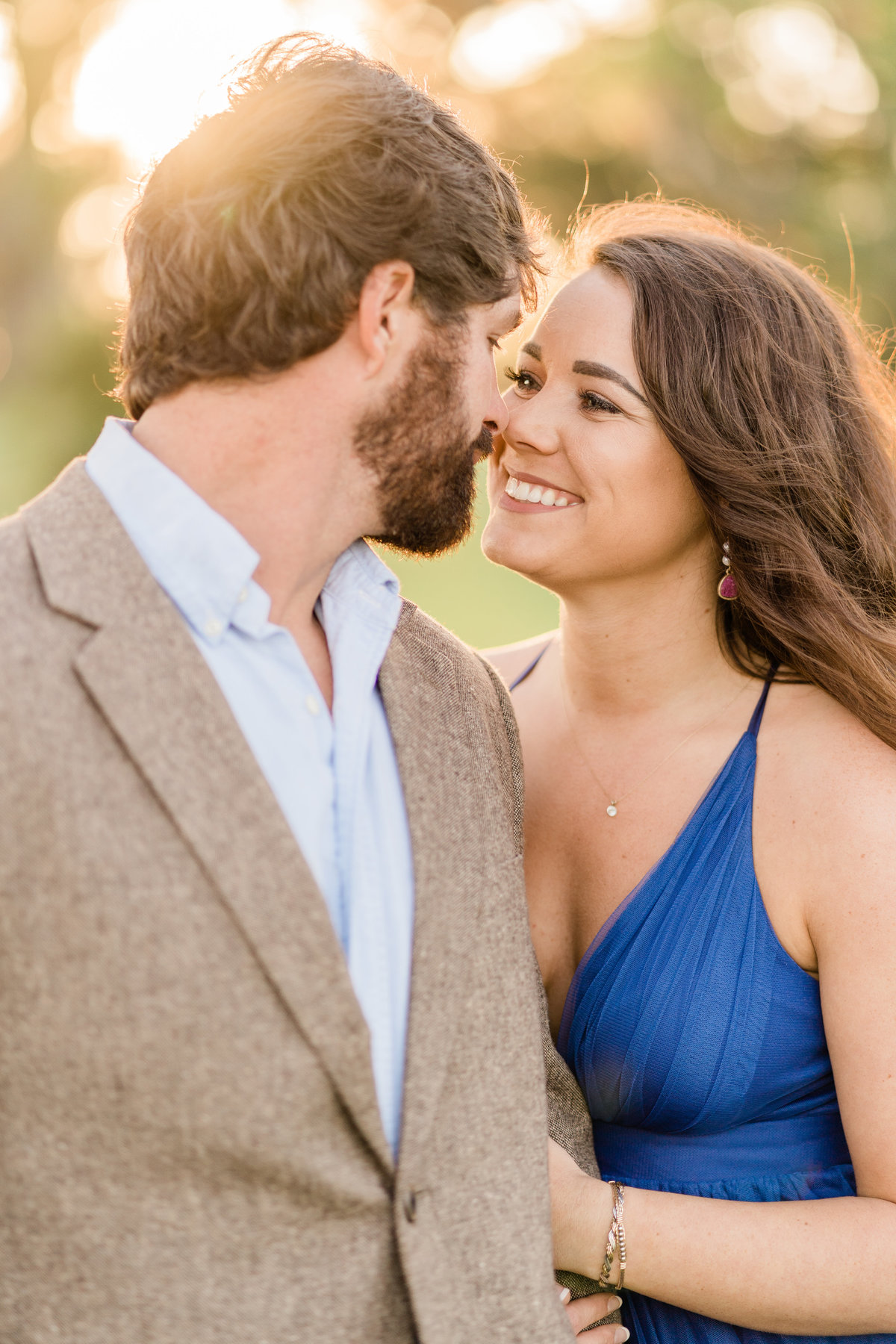 Couple smiling at each other at engagement photoshoot