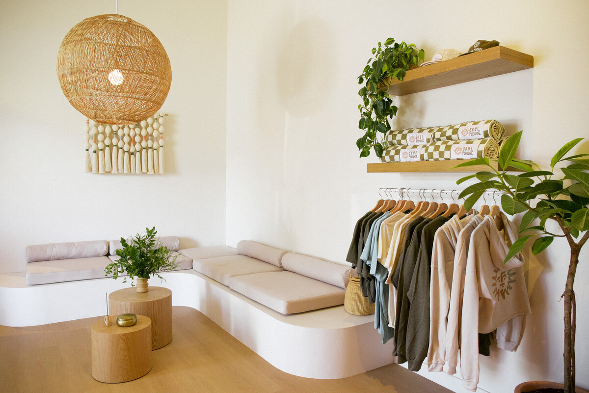 Lobby of beautiful boho yoga studio in San Diego, California. Merchandise is for sale including sweatshirts, t-shirts, sweatshirts and towels.