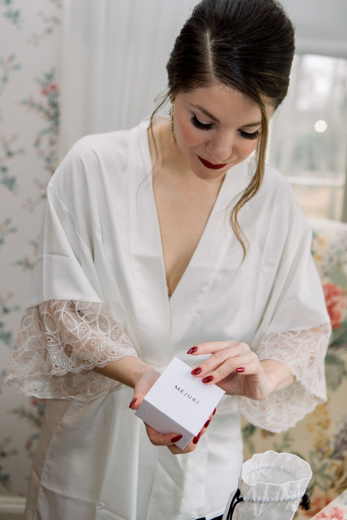 bride opening box before wedding at Lyman Estate in Waltham Massachusetts