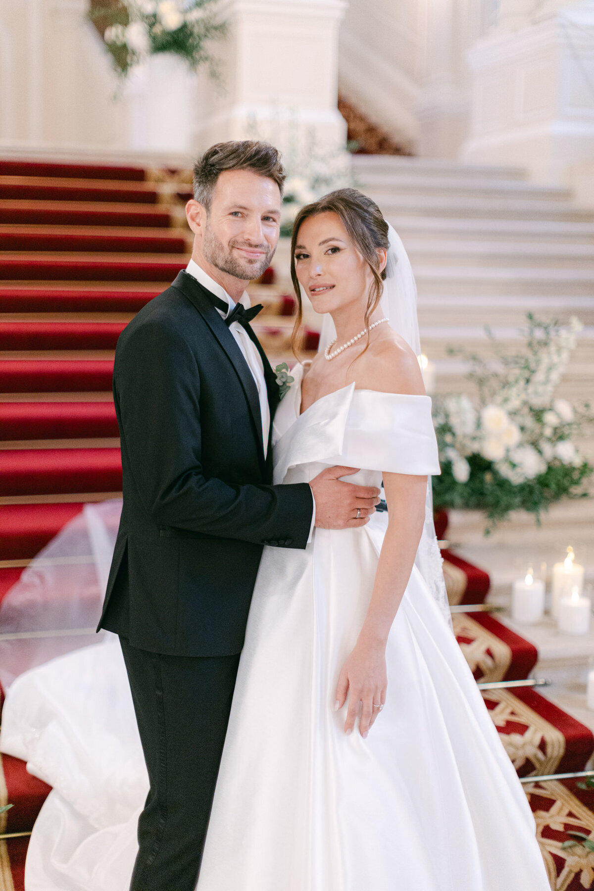 Newlyweds on the stairs at the luxury wedding palace Coburg in Vienna Austria
