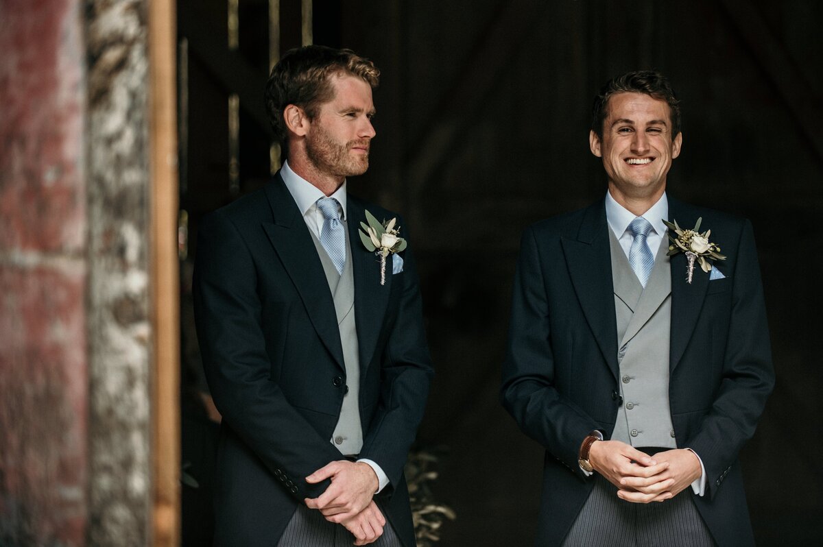 Men in traditional mourning suits with buttonholes of flowers