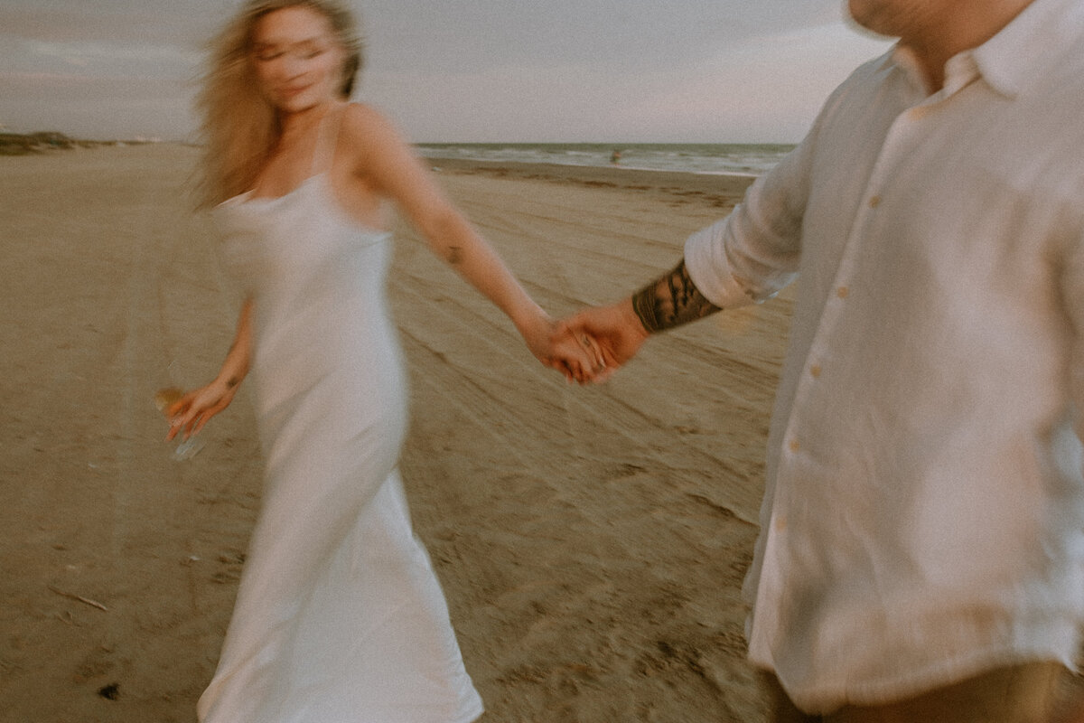 As a wedding photographer capturing an elopement on Galveston's tranquil beaches, I witnessed the raw beauty of love against the endless horizon. With the salty breeze in their hair and the sun setting in the distance, the couple's intimate ceremony was a breathtaking celebration of their bond and the natural splendor of the Texas coast.