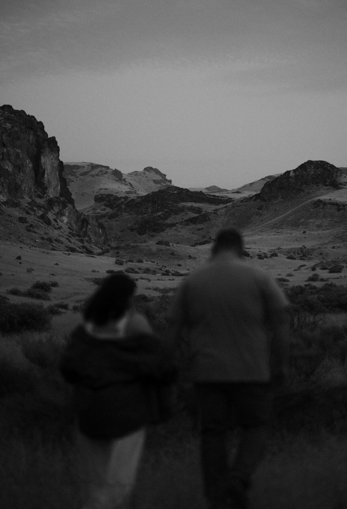 a couple runs off into the distance after eloping in the Moab desert
