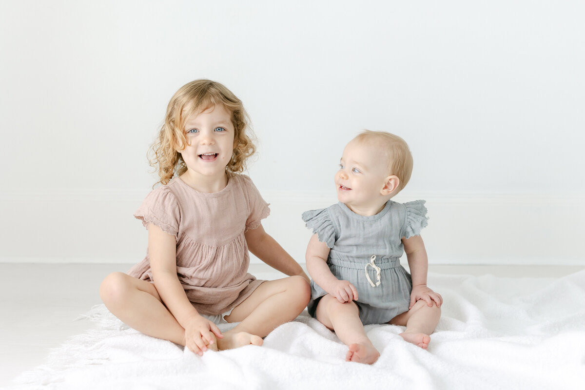 two siblings smiling