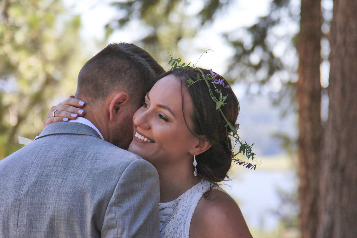 Bride and Groom dancing under canopy of  pine trees at Hauser lake  Idaho