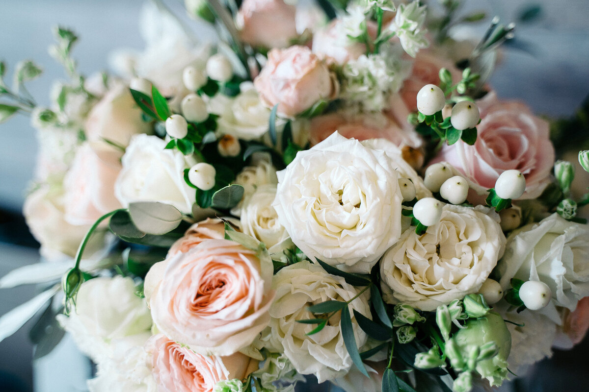 Close up bouquet with pink and white roses styled for mountain view wedding.