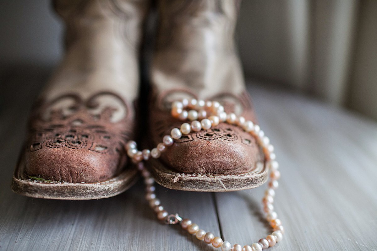 Cowboy boots with pearls resting on them