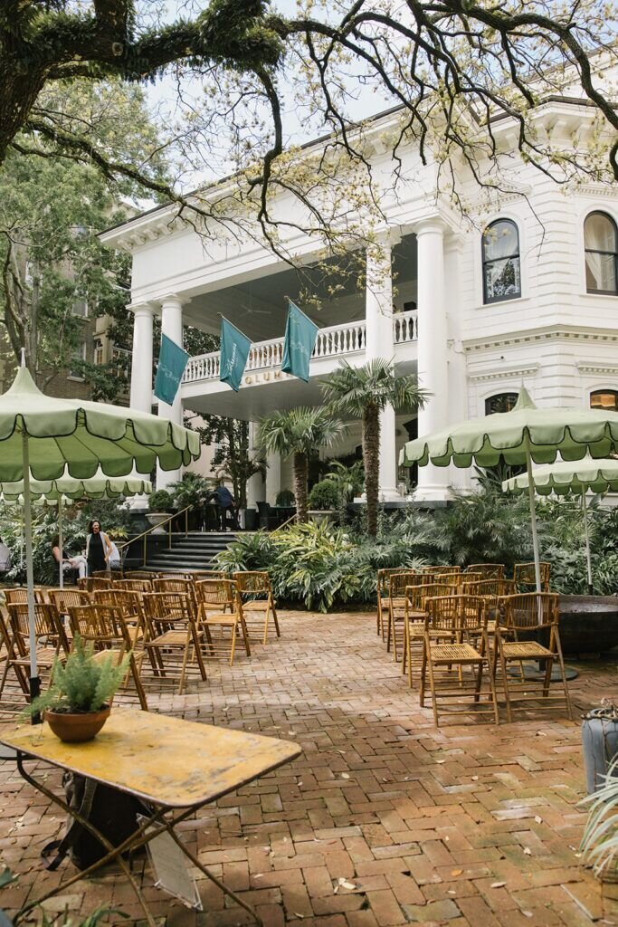 Southern ceremony inspiration with wooden chairs on brick patio under large oak, styled for Sycamore Bend Estate