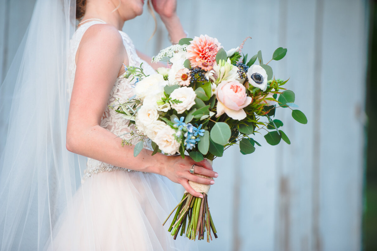 Bride holds bouquet during wedding ceremony at Chandler Hill Vineyard