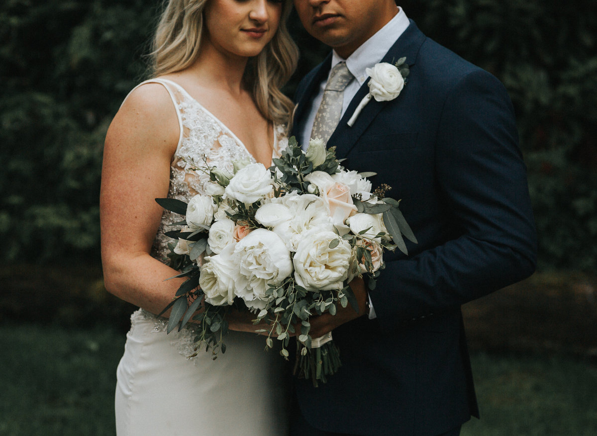 Bride and groom portrait with their boho bouquet in Seattle, Washington.