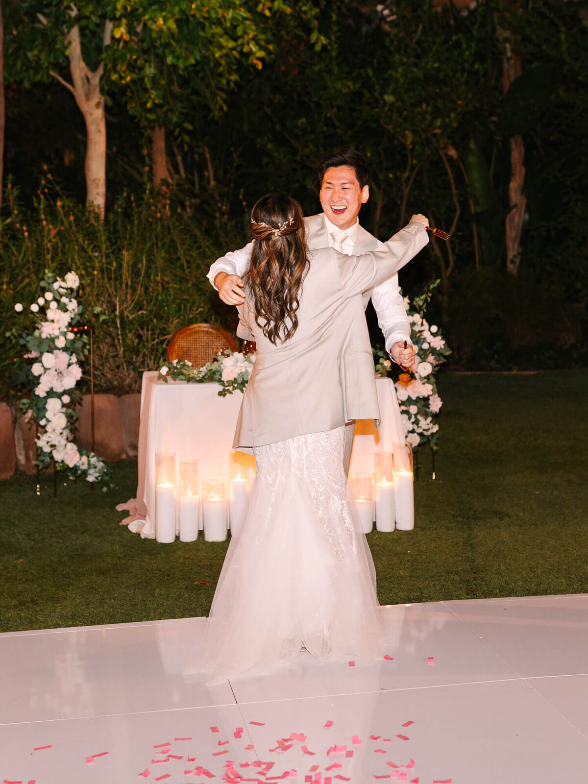 The bride embraces the groom.