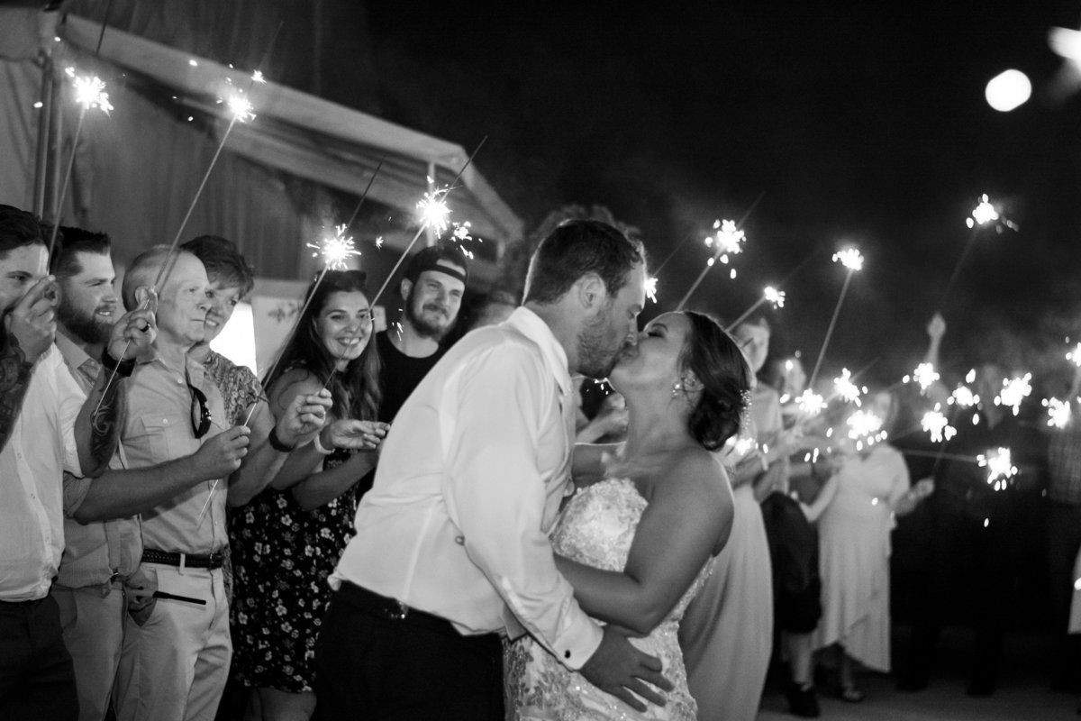 Black and white photo with bride and groom and sparklers