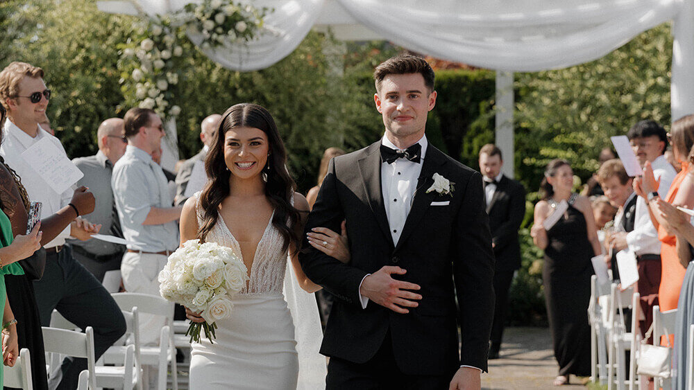 bride and groom walk down aisle after wedding ceremony in Portland Oregon