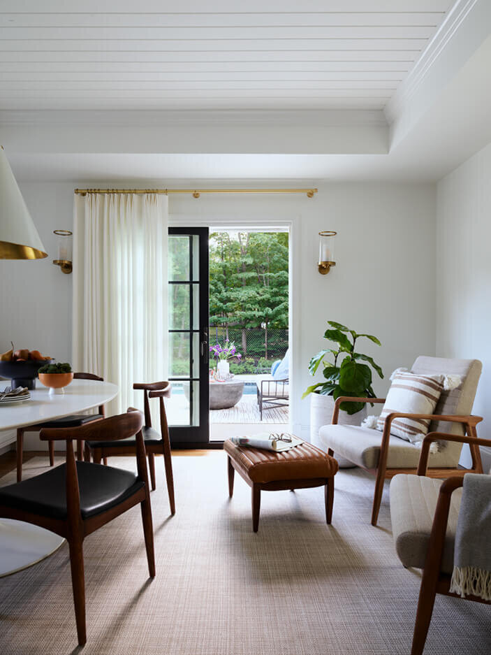 Modern dining area at a historic Hingham home, designed by South Shore decorators, blending contemporary style with the charm of classic architecture.
