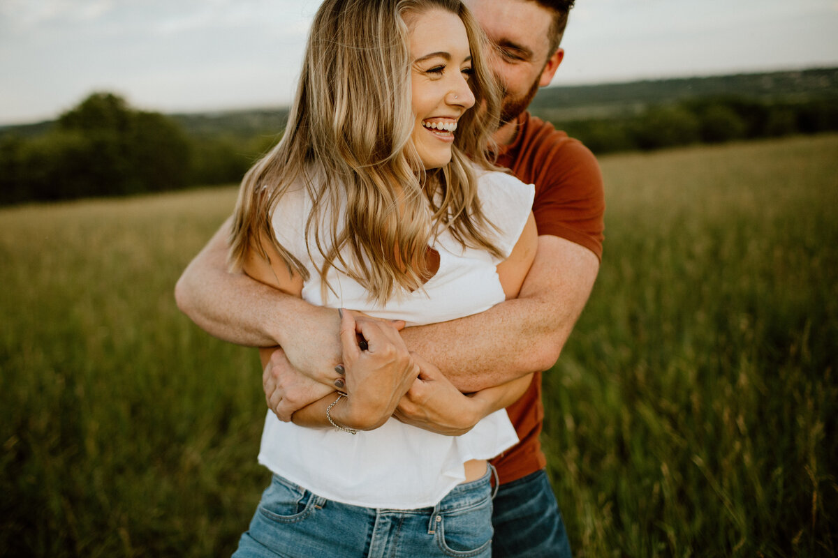 Couple embracing in tall grass