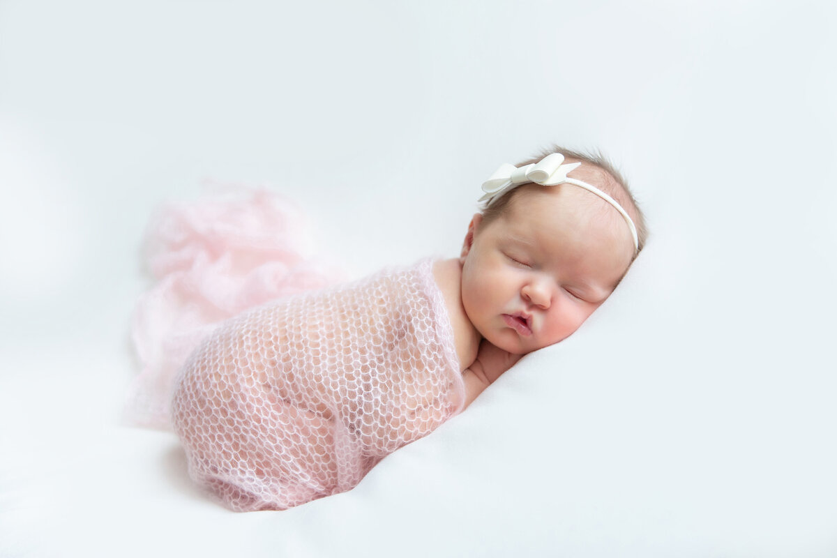 sleeping-newborn-in-pink-wrap