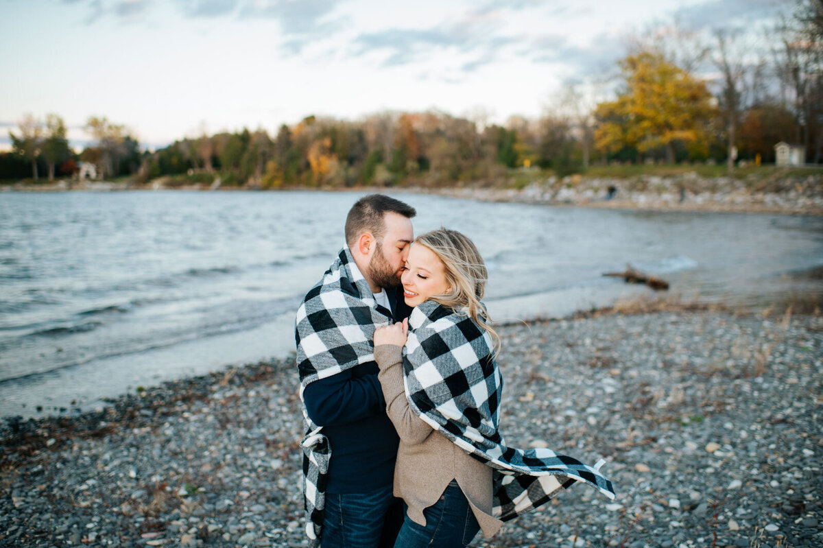 couple wrapped in blanket on beach in charlotte vermont flannel