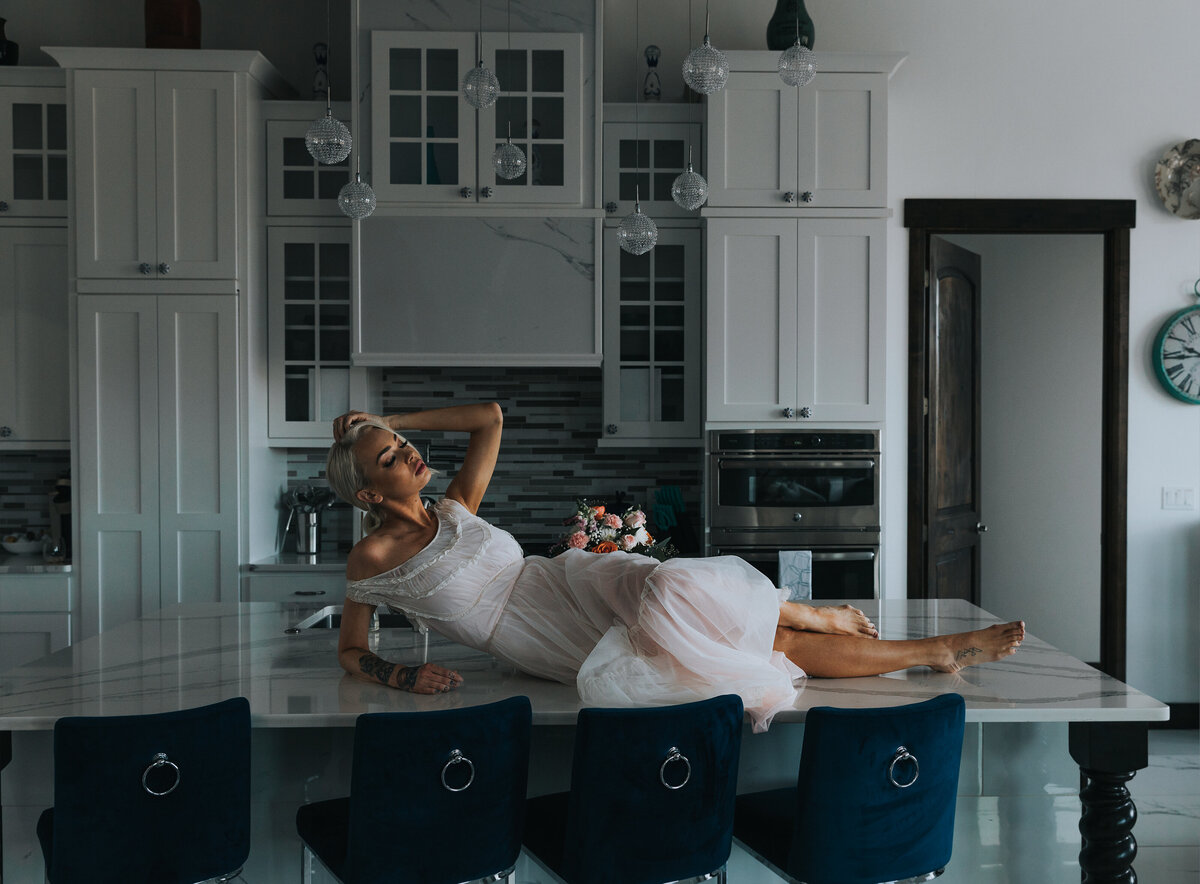Woman posing on the Bonneville salt flats for her boudoir photoshoot