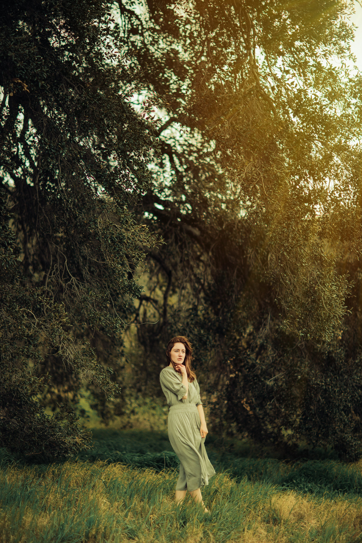 Portrait Photo Of Young Woman In Green Dress Holding Her Chin Los Angeles