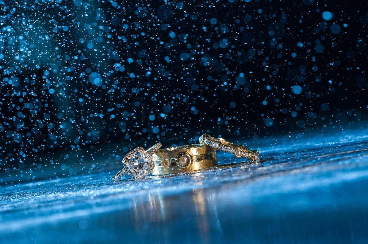 Gold wedding rings with blue rain.