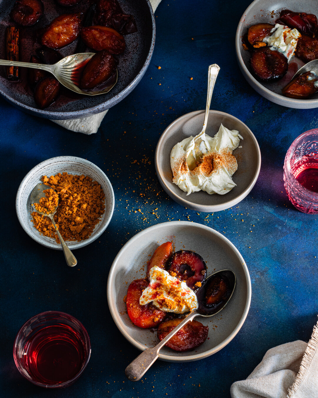 bowls of cooked nectarines and plums with biscuit topping