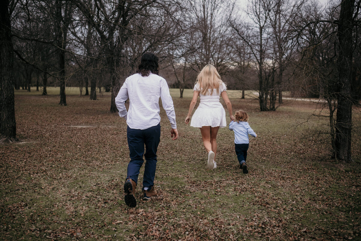 Family photography walking trough woods.
