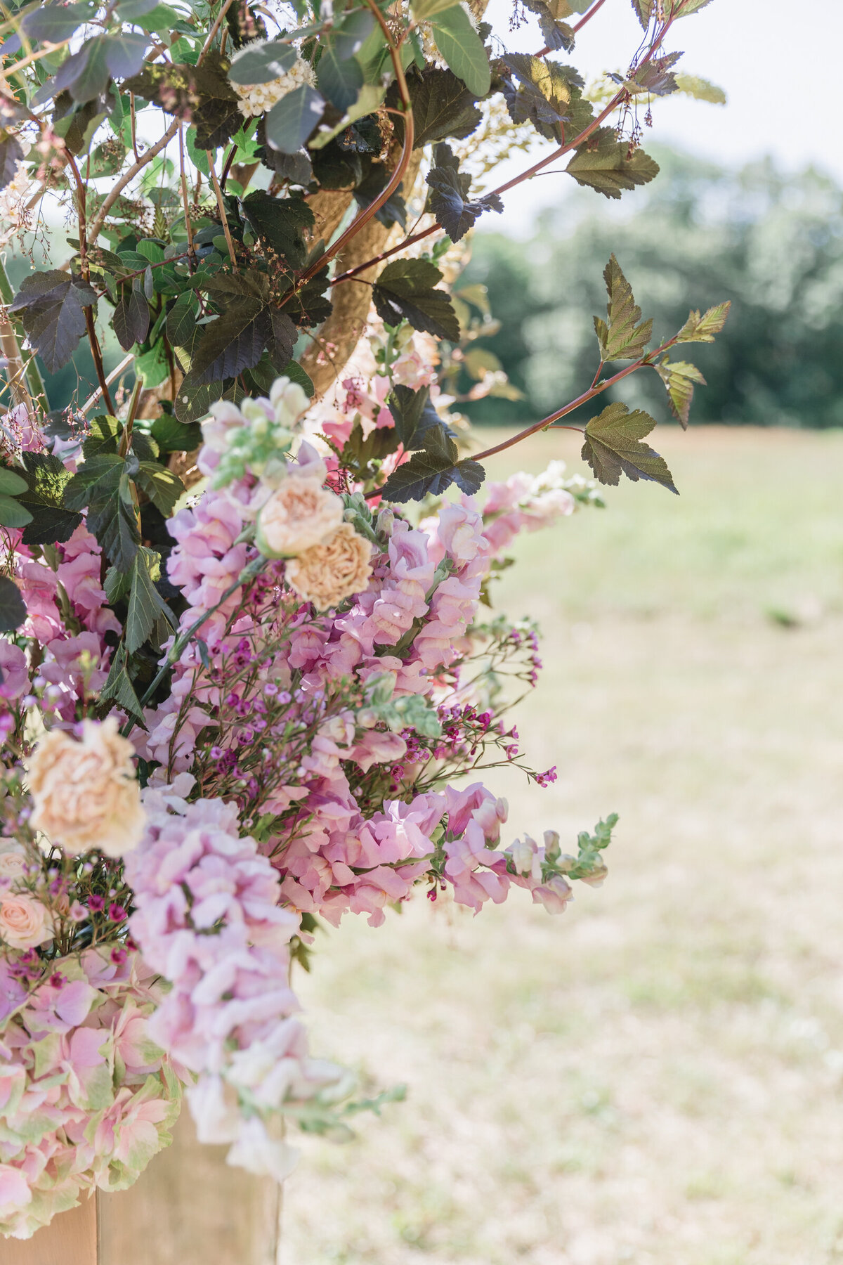 A close up of flowers on a ceremony arch