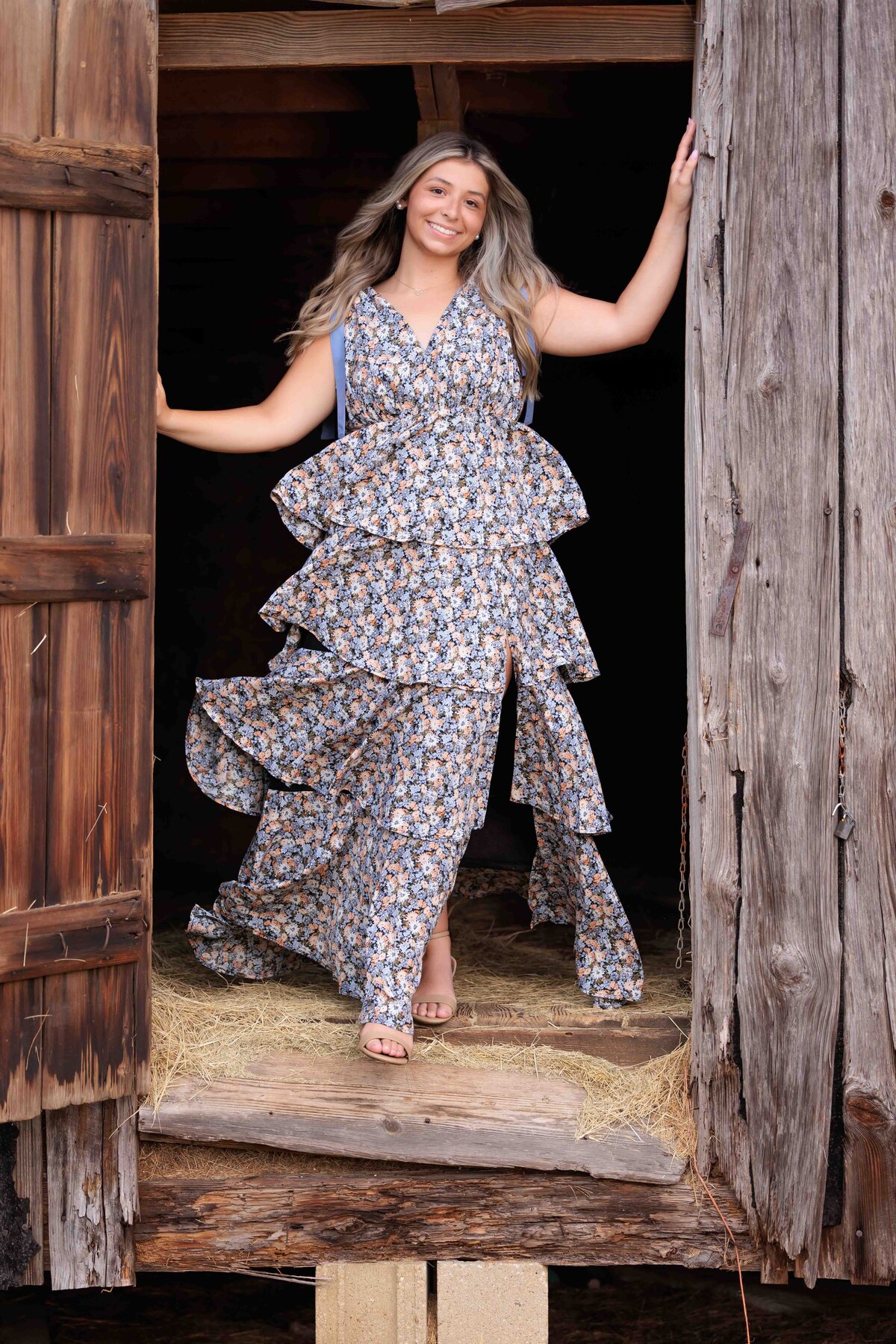 Senior standing in door of old barn in Raleigh NC.