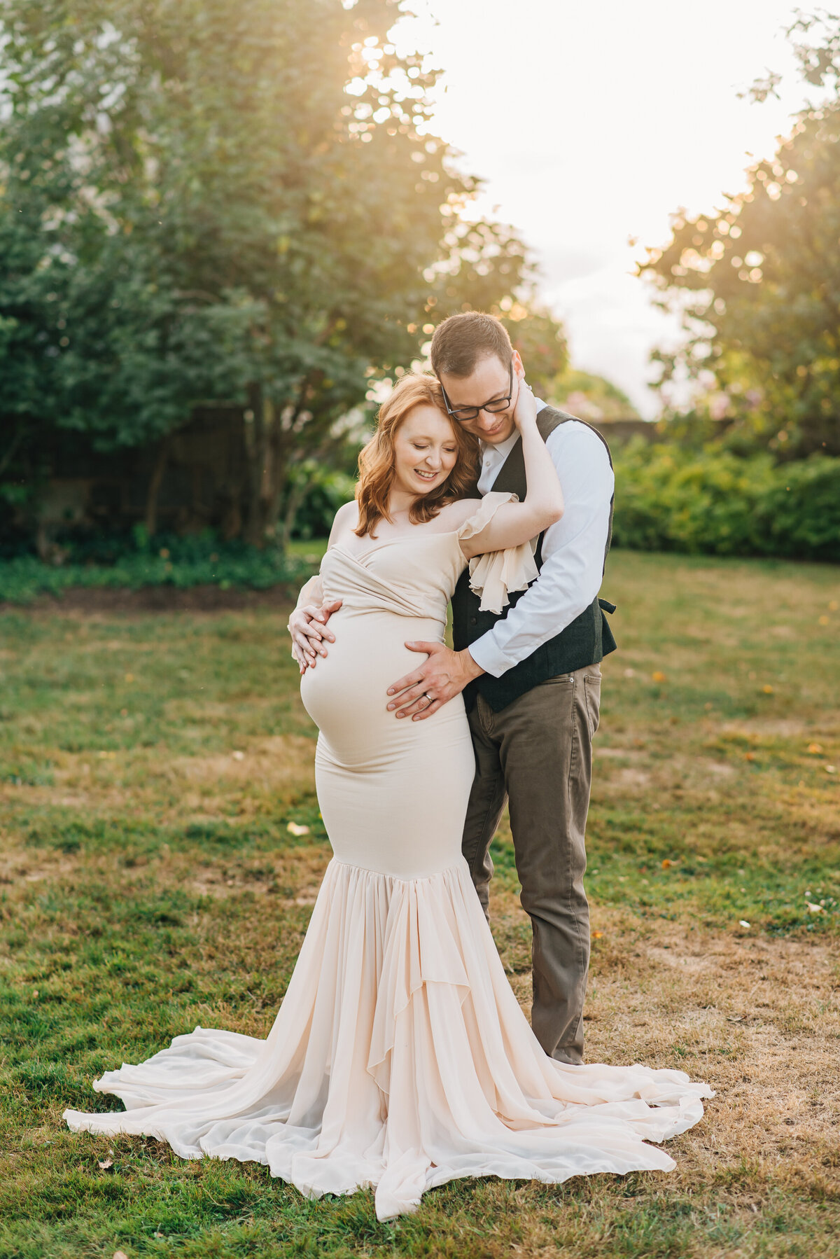 Parents looking down during quiet moment at maternity session