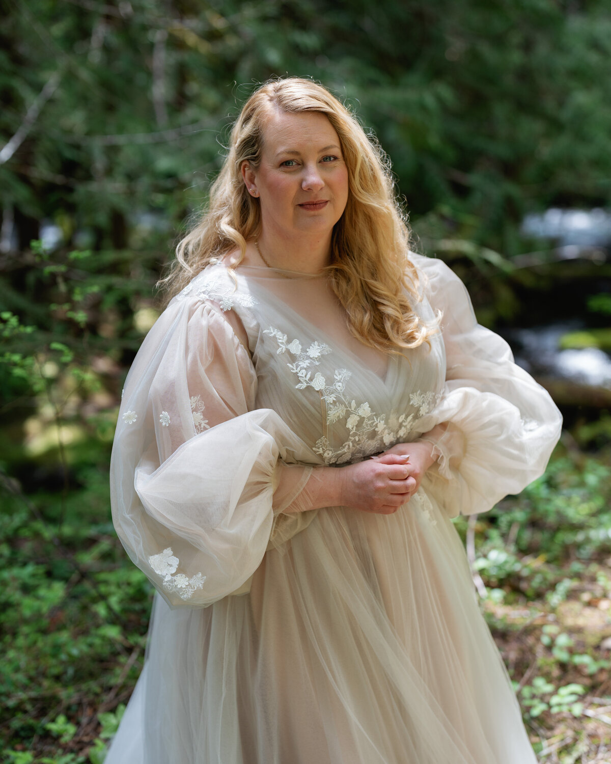 Bride in a tulle long sleeve gown covered in flowers