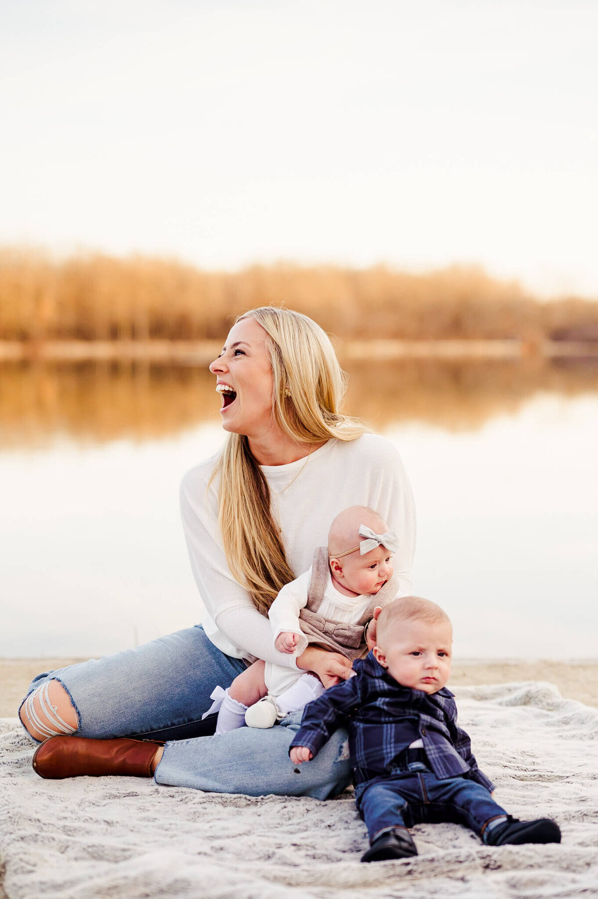 Mother of twins laughing at Herrick Lake in Wheaton during family session.
