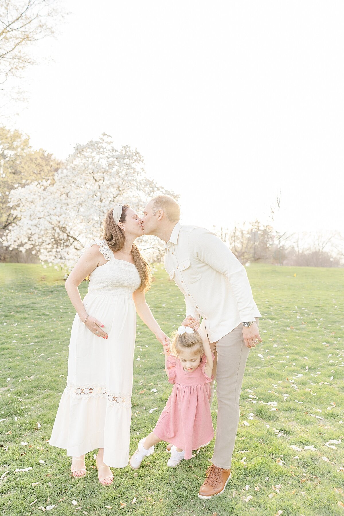 parents kiss during spring maternity photo session in Wellesley Massachusetts with Sara Sniderman Photography