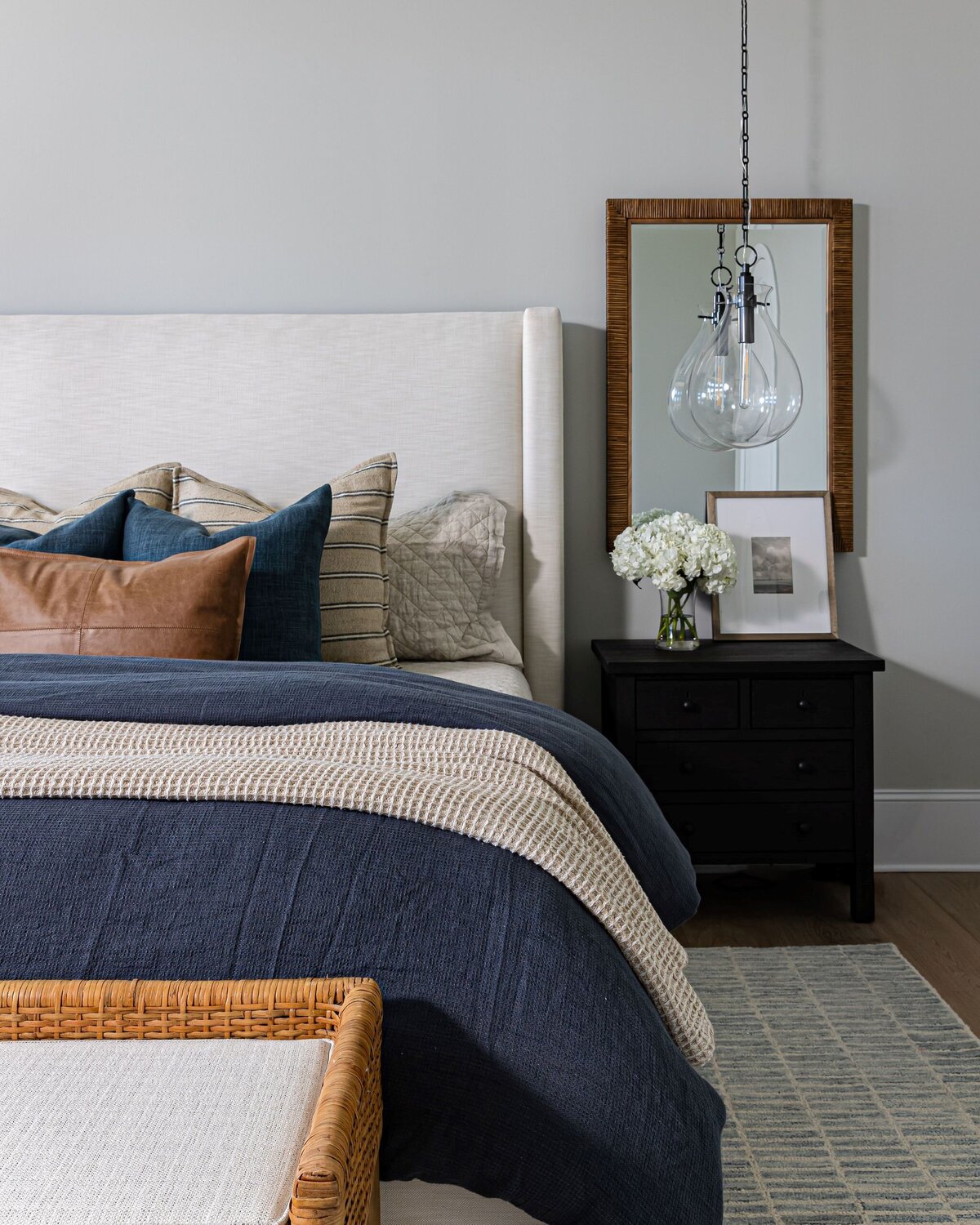 simple bedroom with blue accents and leather pillows