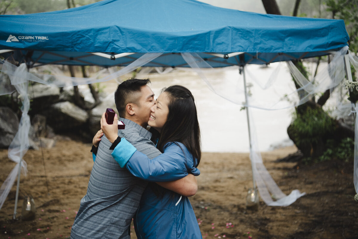 Two people give each other a hug during their proposal.